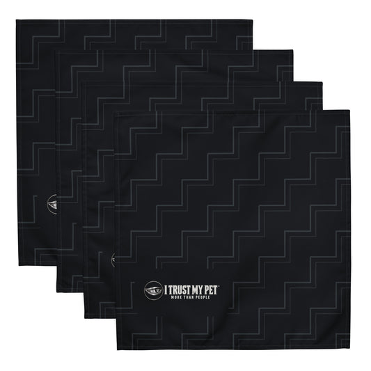 Four black Quiet Company cloth napkins stacked to show the charcoal rising-line pattern and complete I Trust My Pet™ logo.