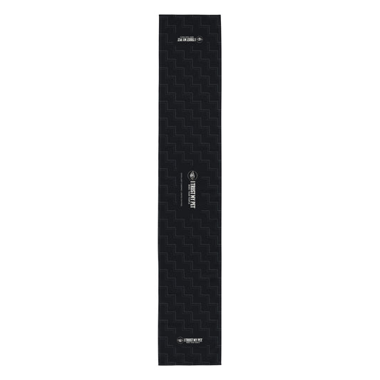 Full-length flat view of the I Trust My Pet™ Quiet Company black table runner, with charcoal rising linework and complete logo details.