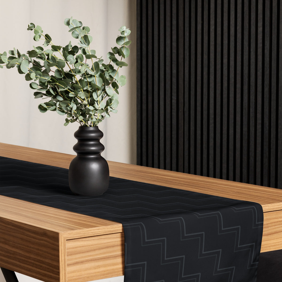 I Trust My Pet™ Quiet Company black table runner styled on a table, showing charcoal linework and the signature logo at the hanging end.