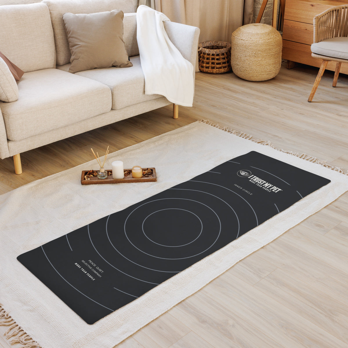 I Trust My Pet™ Inner Circle black yoga mat laid flat in a living room, with signature logo and concentric circle pattern
